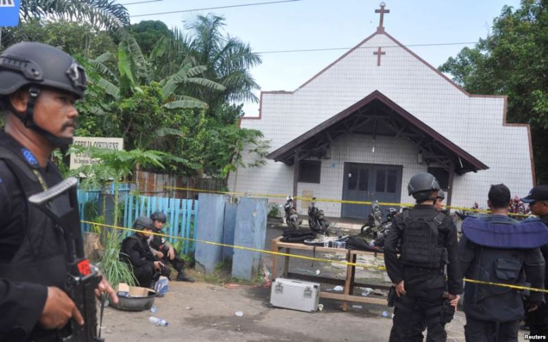 Police stand near the scene of an explosion outside a church in Samarinda, East Kalimantan, Indonesia, Nov. 13, 2016.